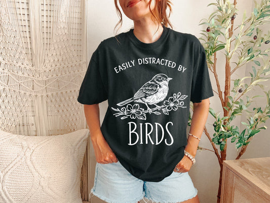 A Black Unisex Garment-Dyed T-shirt mockup (front view) showing the retro bird watching t-shirt - vintage bird nerd apparel print on the front. The artwork highlights garment-dyed, retro bird watching t-shirt - vintage bird nerd apparel, unisex garment-dyed t-shirt, black, retro, bird, watching, t-shirt, -, vintage, describing the graphic and theme on the garment.