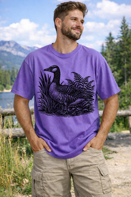 A Violet Unisex Garment-Dyed T-shirt mockup (front view) showing the vintage mallard duck shirt - 90s retro waterfowl graphic tee - gorpcore aesthetic print on the front. The artwork highlights nature lover gift, vintage mallard duck shirt - 90s retro waterfowl graphic tee - gorpcore aesthetic, unisex garment-dyed t-shirt, violet, vintage, mallard, duck, shirt, -, 90s, describing the graphic and theme on the garment.