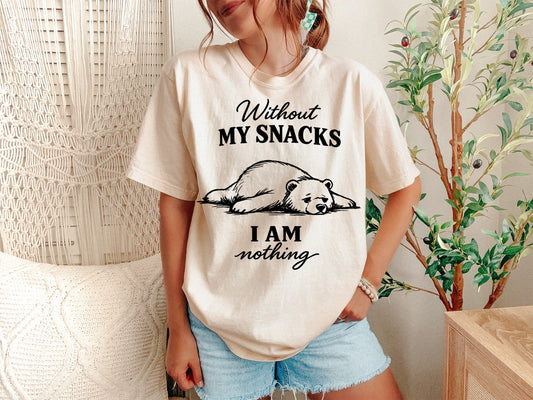 Person wearing a t-shirt with a bear graphic and text in a casual setting.