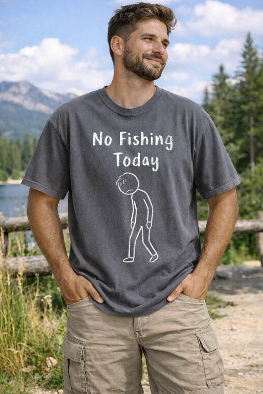 Man wearing a 'No Fishing Today' t-shirt in a scenic outdoor setting with mountains and trees.