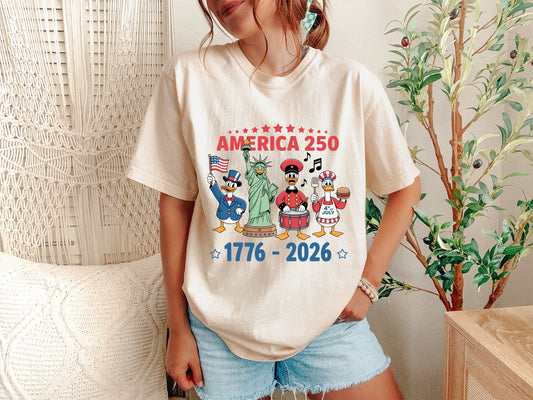 High-quality graphic design for a Comfort Colors 1717 shirt featuring four patriotic silly geese dressed as American icons including Uncle Sam, the Statue of Liberty, and a Revolutionary drummer. The bold text reads 'AMERICA 250' and '1776 - 2026' to honor the USA 250th birthday celebration. This funny Semiquincentennial apparel is a perfect commemorative gift for history buffs and 4th of July fans of the silly goose meme aesthetic.
