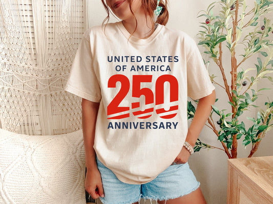 Graphic design for a Comfort Colors 1717 shirt featuring a large red '250' with athletic stripes, flanked by 'UNITED STATES OF AMERICA' and 'ANNIVERSARY' in slate blue. This bold commemorative 1776-2026 design is perfect for patriotic Americans celebrating the US Semiquincentennial and 250th birthday.
