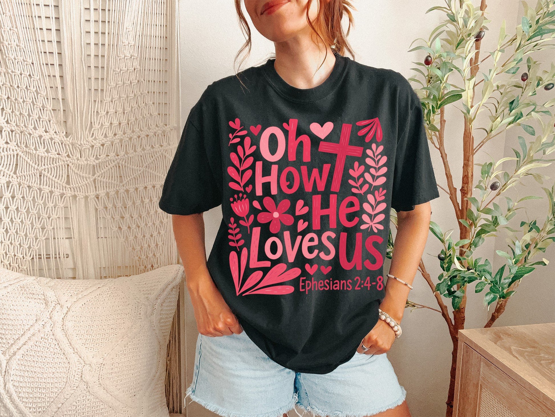 A Black Unisex Garment-Dyed T-shirt mockup (front view) showing the oh how he loves us christian shirt jesus loves us graphic tee print on the front. The artwork highlights shirt, jesus, graphic, tee, unisex, garment-dyed, t-shirt, christian shirt, oh how he loves us, worship lyrics tee, describing the graphic and theme on the garment.