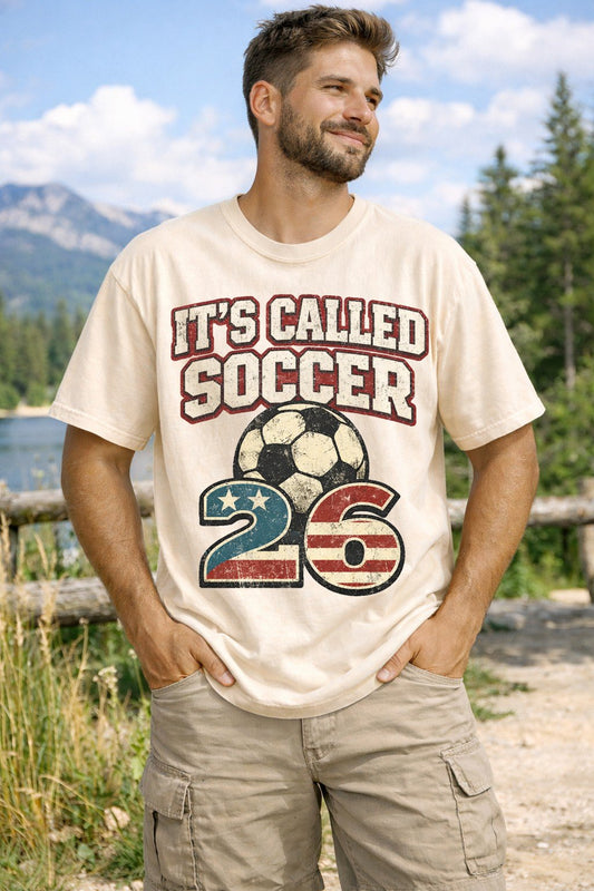A Ivory Unisex Garment-Dyed T-shirt mockup (front view) showing the its called soccer shirt - funny usa football tee - american soccer fan gift print on the front. The artwork highlights funny soccer tee, world cup 2026, usmnt fan gear, soccer vs football, american soccer, soccer fan gift, patriotic shirt, funny sports shirt, soccer coach gift, uswnt shirt, describing the graphic and theme on the garment.