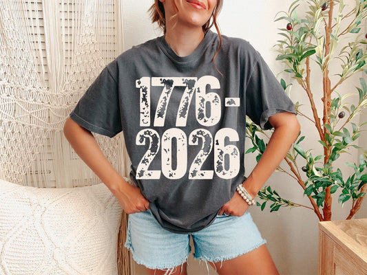 A Pepper Unisex Garment-Dyed T-shirt mockup (front view) showing the semiquincentennial 2026 shirt america 250 years of liberty tee print on the front. The artwork highlights semiquincentennial, 1776 2026 shirt, 250th anniversary, usa 250 shirt, patriotic 2026, freedom shirt, independence day 2026, 250 years of liberty, commemorative shirt, us history gift, describing the graphic and theme on the garment.