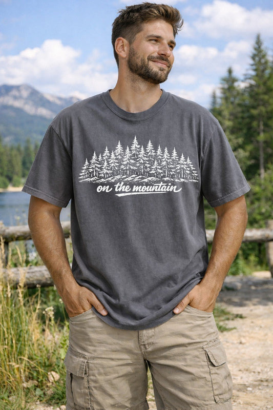 A Pepper Unisex Garment-Dyed T-shirt mockup (front view) showing the granola girl hiking shirt - minimalist mountain graphic print on the front. The artwork highlights funny hiking gift, gorpcore clothing, retro adventure, nature lover gift, outdoorsy shirt, mountain graphic, trail running tee, camping shirt, granola girl, national park, describing the graphic and theme on the garment.