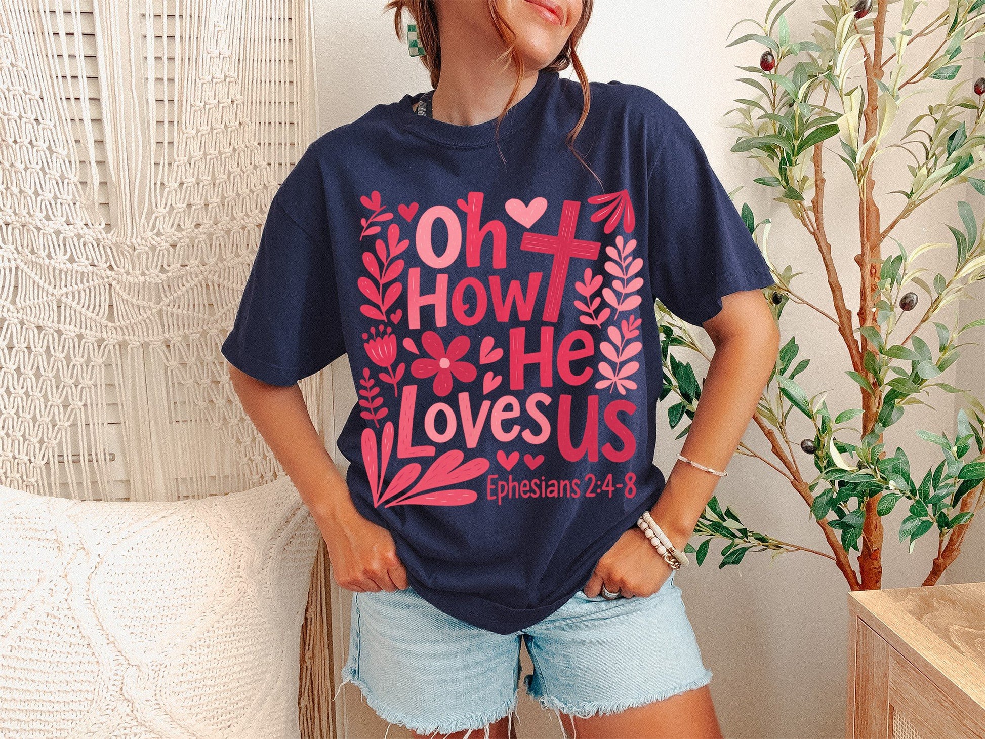 A True Navy Unisex Garment-Dyed T-shirt mockup (front view) showing the oh how he loves us christian shirt jesus loves us graphic tee print on the front. The artwork highlights aesthetic christian, comfort colors tee, bible verse shirt, religious clothing, boho christian, minimalist jesus, christian girl gift, sunday church shirt, oh how he loves us christian shirt jesus loves us graphic tee, unisex garment-dyed t-shirt, describing the graphic and theme on the garment.