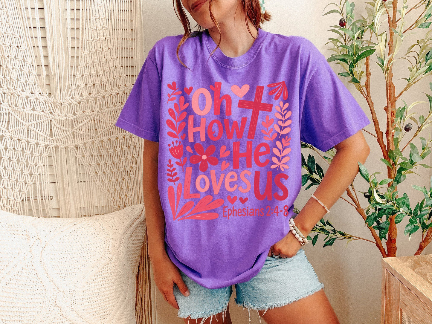 A Violet Unisex Garment-Dyed T-shirt mockup (front view) showing the oh how he loves us christian shirt jesus loves us graphic tee print on the front. The artwork highlights violet, oh, how, he, loves, us, christian, shirt, jesus, graphic, describing the graphic and theme on the garment.