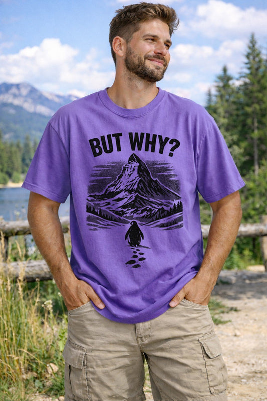 A Violet Unisex Garment-Dyed T-shirt mockup (front view) showing the nihilist penguin heading to mountains t-shirt - existential humor print on the front. The artwork highlights sarcastic t-shirt, nihilist penguin heading to mountains t-shirt - existential humor, unisex garment-dyed t-shirt, violet, nihilist, penguin, heading, to, mountains, t-shirt, describing the graphic and theme on the garment.