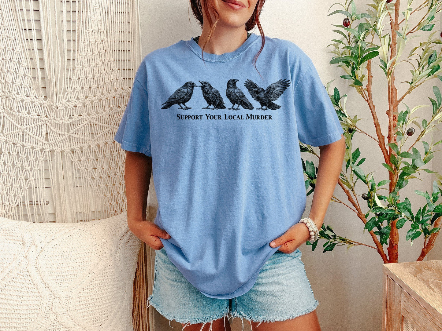 A Washed Denim Unisex Garment-Dyed T-shirt mockup (front view) showing the support your local murder crow shirt - funny bird lover gift - dark academia raven tee print on the front. The artwork highlights bird, lover, gift, dark, academia, raven, tee, unisex, garment-dyed, t-shirt, describing the graphic and theme on the garment.