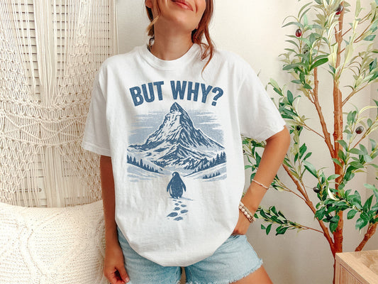 A White Unisex Garment-Dyed T-shirt mockup (front view) showing the nihilist penguin heading to mountains t-shirt - existential humor print on the front. The artwork highlights sarcastic t-shirt, nihilist penguin heading to mountains t-shirt - existential humor, unisex garment-dyed t-shirt, white, nihilist, penguin, heading, to, mountains, t-shirt, describing the graphic and theme on the garment.