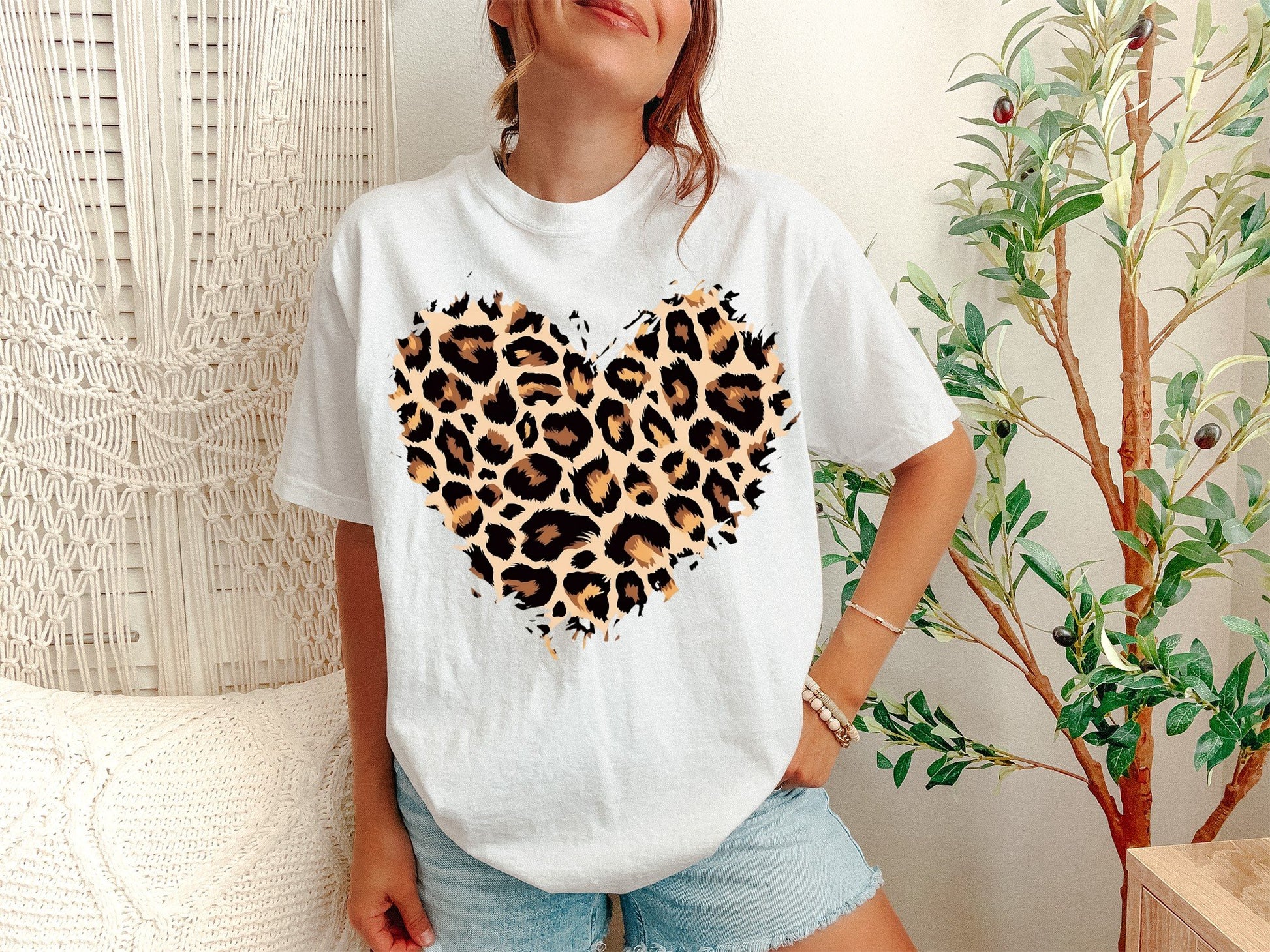 A White Unisex Garment-Dyed T-shirt mockup (front view) showing the leopard heart shirt - cute valentines day animal print tee print on the front. The artwork highlights matching leopard hearts, leopard heart hoodie, small leopard heart, large leopard heart, leopard heart pocket, rainbow leopard heart, black leopard heart, white leopard heart, grey leopard heart, leopard heart patch, describing the graphic and theme on the garment.